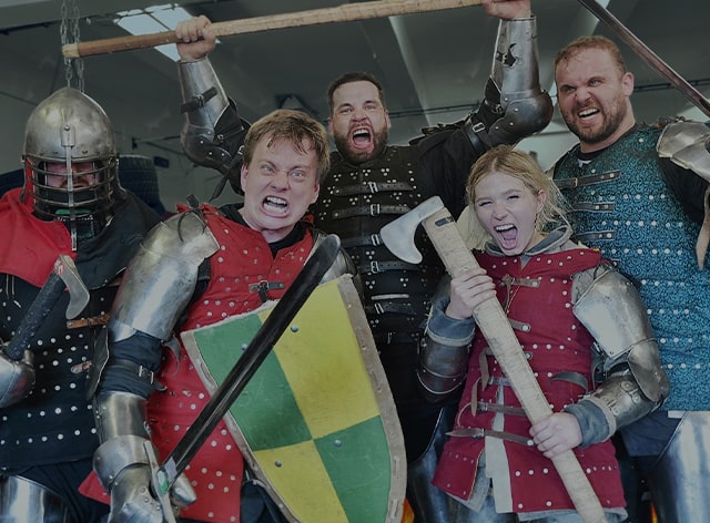 A competitor lifts a&nbsp;massive wooden log overhead in front of a&nbsp;SWAGLIFT DAY banner